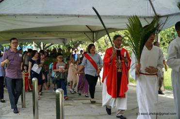 Several children and the churchgoers following Fr Cosmas Lee into the main church during the procession.